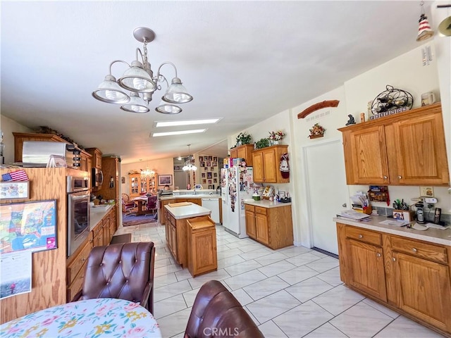 38727 State Highway 96, Klamath River, CA 96050 - kitchen with a chandelier, white appliances, light countertops, a kitchen island, and hanging light fixtures