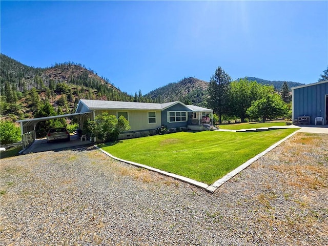 38727 State Highway 96, Klamath River, CA 96050 - view of side of home with a mountain view, driveway, a yard, and a carport