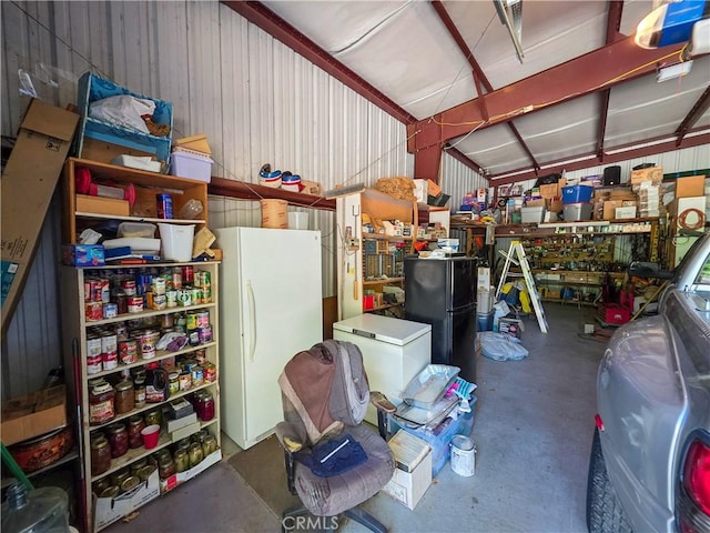 38727 State Highway 96, Klamath River, CA 96050 - garage featuring freestanding refrigerator, wooden walls, and a workshop area