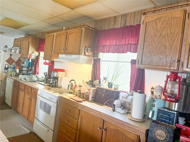 38727 State Highway 96, Klamath River, CA 96050 - kitchen featuring white appliances, under cabinet range hood, light countertops, healthy amount of natural light, and a paneled ceiling