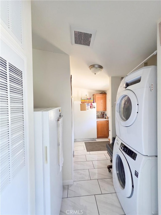 38727 State Highway 96, Klamath River, CA 96050 - washroom featuring stacked washing machine and dryer and light marble finish flooring
