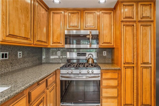 100 Waters Ct, Redlands, CA 92374 - kitchen with stainless steel appliances and brown cabinets