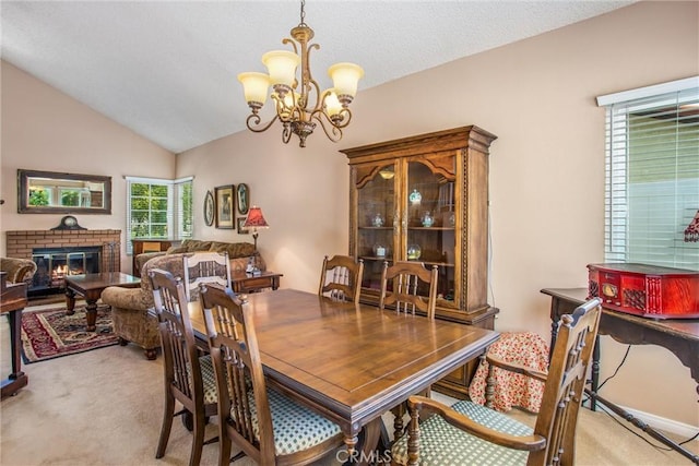 100 Waters Ct, Redlands, CA 92374 - dining room featuring light carpet, a chandelier, a fireplace, and lofted ceiling