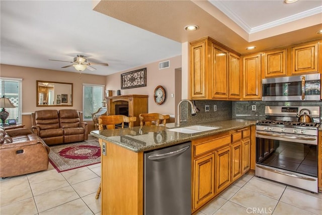 100 Waters Ct, Redlands, CA 92374 - kitchen with appliances with stainless steel finishes, a sink, healthy amount of natural light, open floor plan, and crown molding