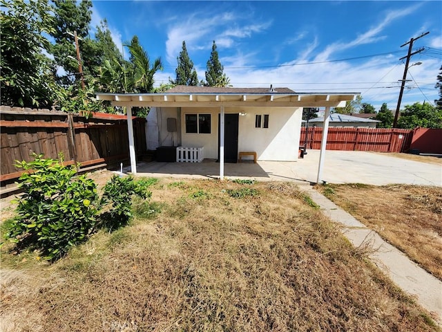 10450 Balboa Blvd, Granada Hills, CA 91344 - back of property featuring a patio, stucco siding, and a fenced backyard