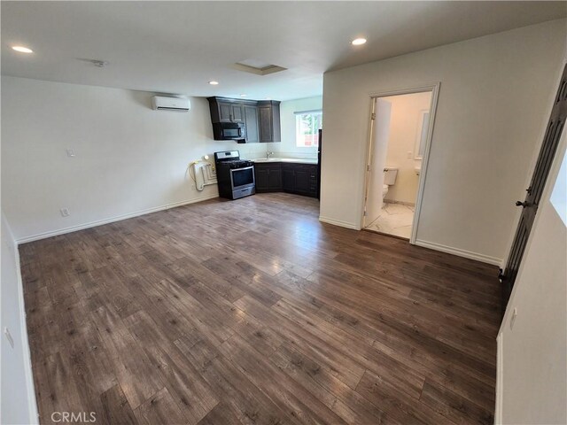 10450 Balboa Blvd, Granada Hills, CA 91344 - unfurnished living room featuring a wall mounted AC, dark wood-style floors, recessed lighting, and baseboards