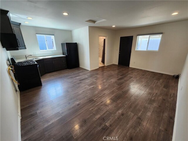 10450 Balboa Blvd, Granada Hills, CA 91344 - unfurnished living room with a sink, healthy amount of natural light, dark wood-style floors, baseboards, and recessed lighting