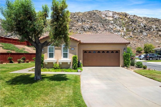 197 Inkster Way, Hemet, CA 92545 - mediterranean / spanish-style house with an attached garage, concrete driveway, a tile roof, stucco siding, and a mountain view