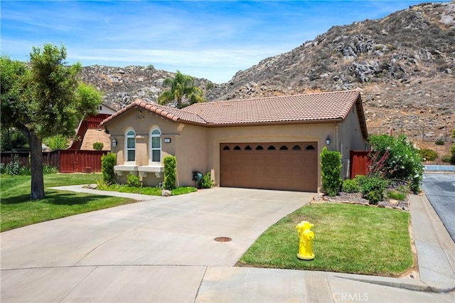 197 Inkster Way, Hemet, CA 92545 - mediterranean / spanish-style house featuring a mountain view, a tile roof, an attached garage, stucco siding, and concrete driveway
