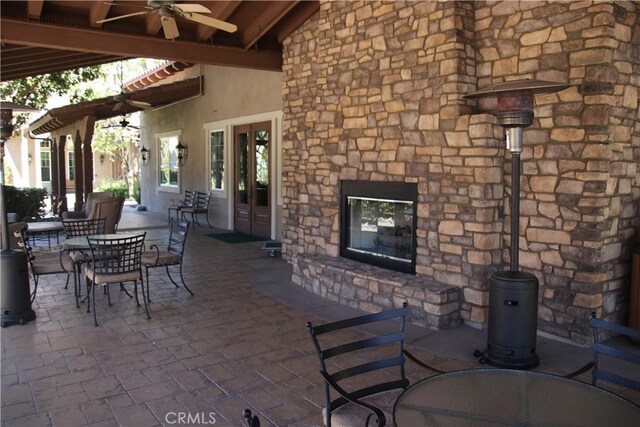 197 Inkster Way, Hemet, CA 92545 - view of patio / terrace featuring an outdoor stone fireplace, outdoor dining area, and a ceiling fan