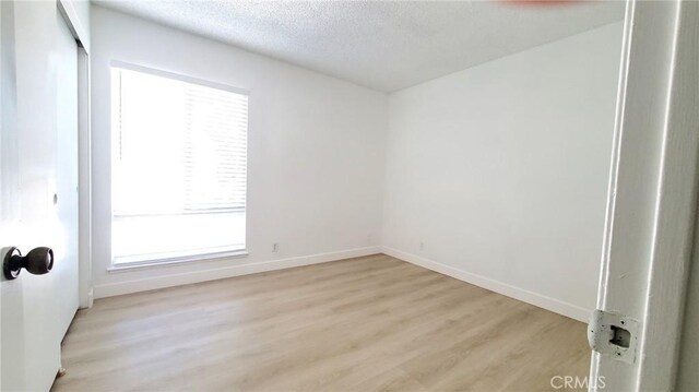 17070 Colima Rd Unit 284, Hacienda Heights, CA 91745 - unfurnished room featuring light wood finished floors, baseboards, and a textured ceiling