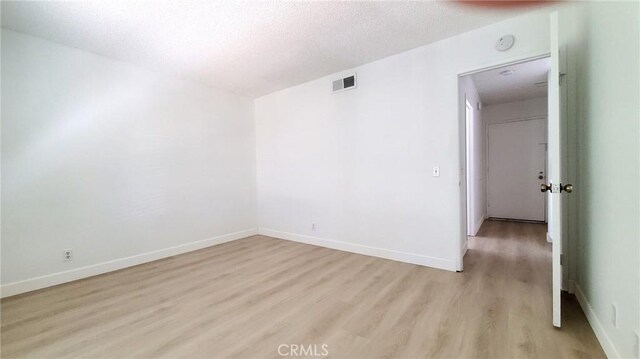 17070 Colima Rd Unit 284, Hacienda Heights, CA 91745 - unfurnished room featuring light wood-type flooring, a textured ceiling, and baseboards