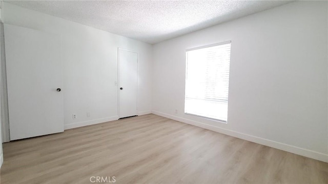 17070 Colima Rd Unit 284, Hacienda Heights, CA 91745 - empty room with light wood-style floors, a textured ceiling, and baseboards