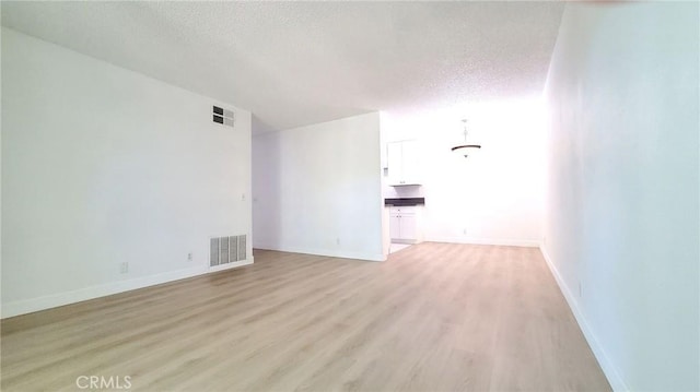 17070 Colima Rd Unit 284, Hacienda Heights, CA 91745 - unfurnished room featuring a textured ceiling, light wood-type flooring, and baseboards