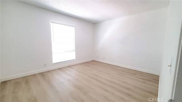 17070 Colima Rd Unit 284, Hacienda Heights, CA 91745 - unfurnished room featuring light wood-type flooring, a textured ceiling, and baseboards