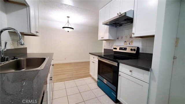 17070 Colima Rd Unit 284, Hacienda Heights, CA 91745 - kitchen with electric range oven, under cabinet range hood, a sink, dark countertops, and white cabinets