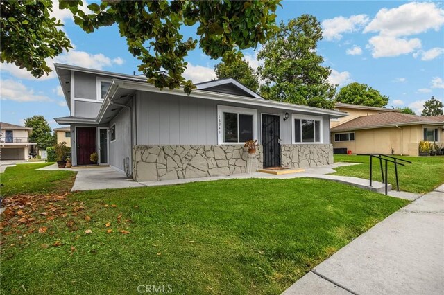 18241 Via Calma Unit 1, Rowland Heights, CA 91748 - view of front of house featuring a front lawn and stone siding