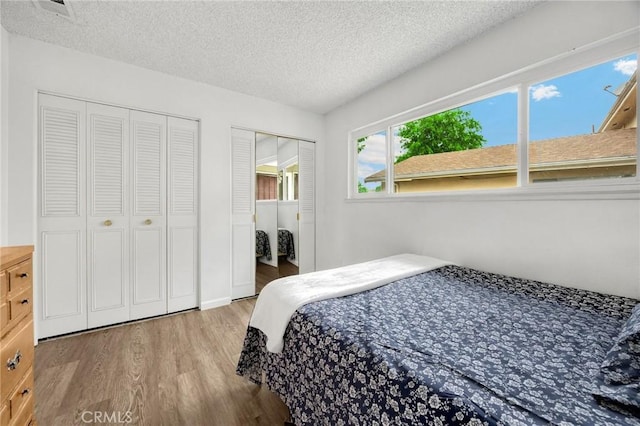 18241 Via Calma Unit 1, Rowland Heights, CA 91748 - bedroom with wood finished floors, multiple closets, and a textured ceiling
