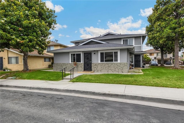 18241 Via Calma Unit 1, Rowland Heights, CA 91748 - view of front facade featuring stone siding, a front lawn, stucco siding, and a shingled roof