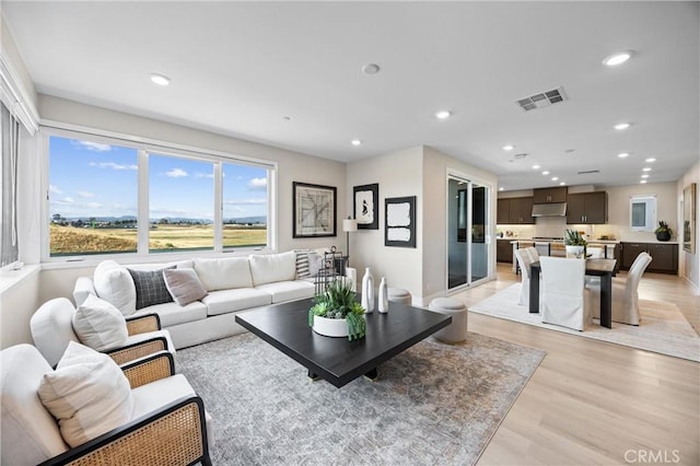 225 Waypoint, Tustin, CA 92782 - living area featuring light wood finished floors and recessed lighting