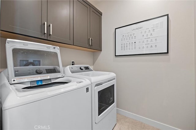 225 Waypoint, Tustin, CA 92782 - laundry room featuring washer and clothes dryer, cabinet space, baseboards, and light tile patterned floors