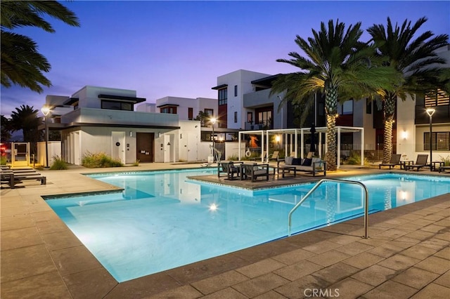 225 Waypoint, Tustin, CA 92782 - pool at dusk featuring a community pool and a patio area