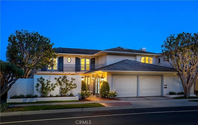 1100 Polaris Dr, Newport Beach, CA 92660 - view of front of property featuring a garage, driveway, stucco siding, and a balcony