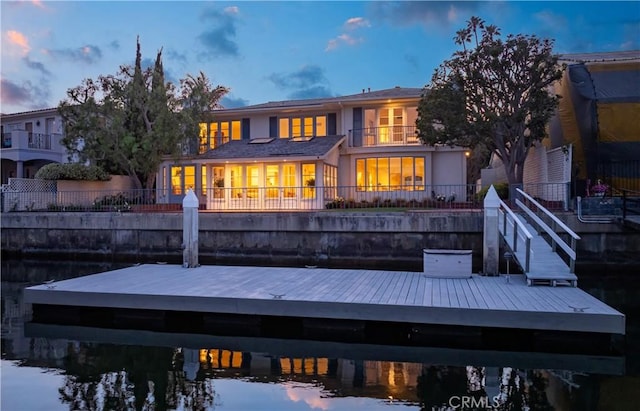 1100 Polaris Dr, Newport Beach, CA 92660 - back of house at dusk with a balcony and stucco siding