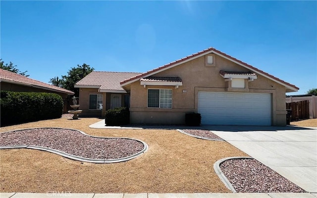12390 San Dimas St, Victorville, CA 92392 - view of front of property with stucco siding, a tile roof, concrete driveway, and a garage