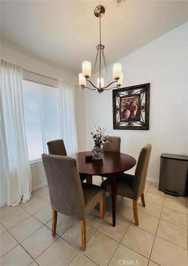 12390 San Dimas St, Victorville, CA 92392 - dining area with a chandelier, light tile patterned floors, and baseboards