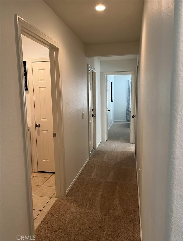 12390 San Dimas St, Victorville, CA 92392 - corridor featuring light tile patterned floors, recessed lighting, baseboards, and light colored carpet