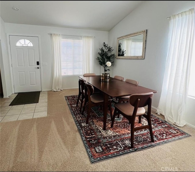 12390 San Dimas St, Victorville, CA 92392 - dining room with light colored carpet, lofted ceiling, baseboards, and light tile patterned floors
