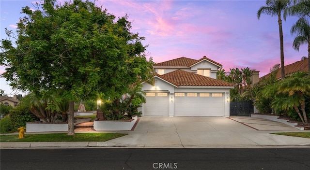 950 Chantel Dr, Corona, CA 92879 - mediterranean / spanish-style house featuring an attached garage, driveway, a tile roof, and stucco siding