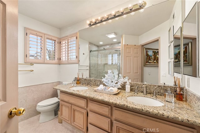 950 Chantel Dr, Corona, CA 92879 - full bathroom with double vanity, toilet, a shower stall, tile patterned flooring, and a wainscoted wall