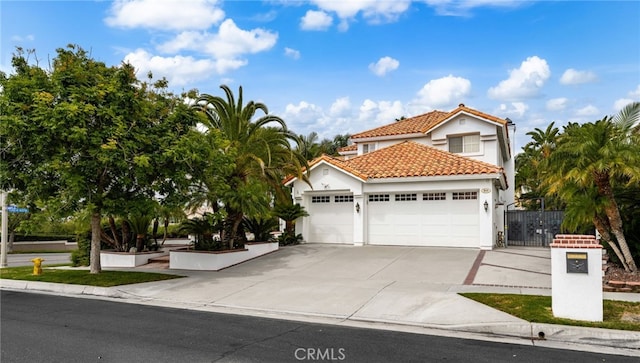 950 Chantel Dr, Corona, CA 92879 - mediterranean / spanish house with an attached garage, concrete driveway, stucco siding, and a tiled roof