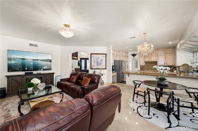 950 Chantel Dr, Corona, CA 92879 - living area with a chandelier, arched walkways, and light marble finish flooring