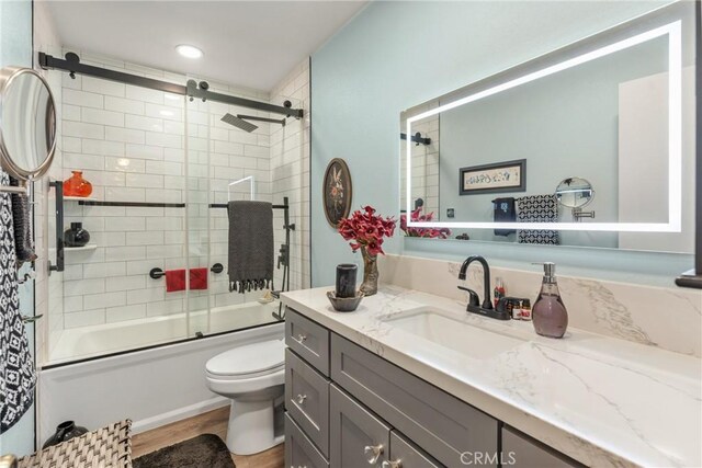 46 Lincoln Ct, Buena Park, CA 90620 - full bathroom featuring toilet, vanity, bath / shower combo with glass door, and wood finished floors