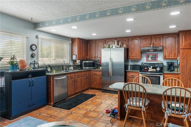 46 Lincoln Ct, Buena Park, CA 90620 - kitchen with appliances with stainless steel finishes, under cabinet range hood, a sink, recessed lighting, and brown cabinetry
