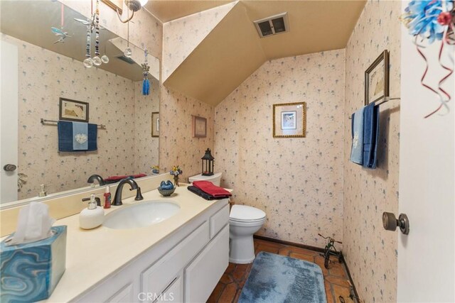 46 Lincoln Ct, Buena Park, CA 90620 - bathroom featuring vanity, toilet, vaulted ceiling, and tile patterned floors