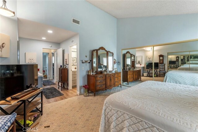 46 Lincoln Ct, Buena Park, CA 90620 - bedroom with wood finished floors, high vaulted ceiling, and recessed lighting