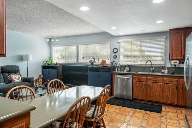 46 Lincoln Ct, Buena Park, CA 90620 - kitchen featuring stainless steel dishwasher, a sink, brown cabinetry, recessed lighting, and light tile patterned floors