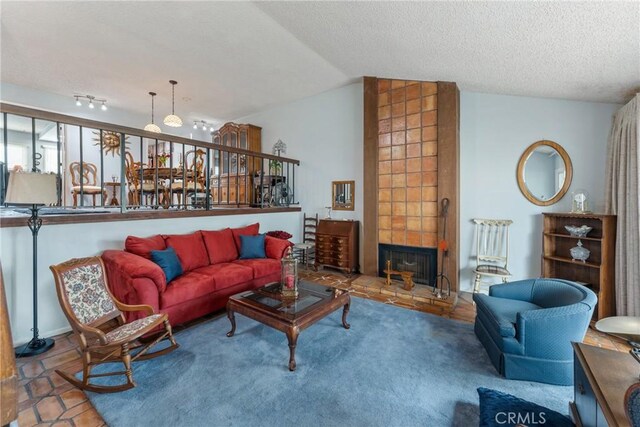 46 Lincoln Ct, Buena Park, CA 90620 - carpeted living area with a textured ceiling, vaulted ceiling, and a fireplace