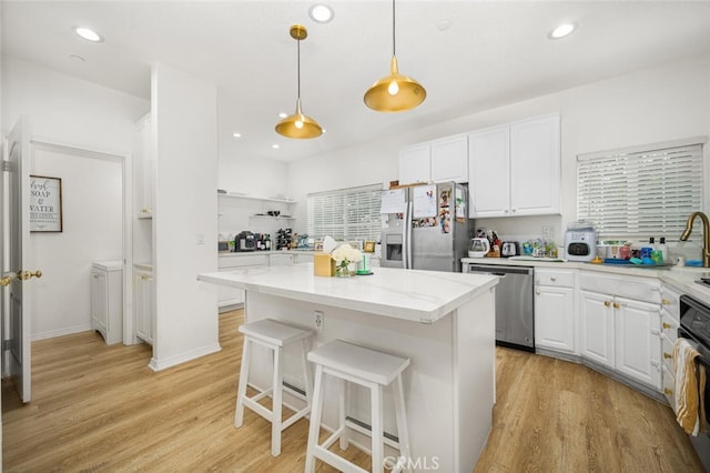 5740 S Glennie Ln Unit C, Los Angeles, CA 90016 - kitchen featuring stainless steel appliances, white cabinetry, light wood finished floors, a center island, and recessed lighting