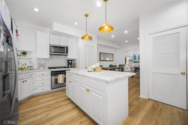 5740 S Glennie Ln Unit C, Los Angeles, CA 90016 - kitchen featuring stainless steel appliances, light wood-style flooring, recessed lighting, white cabinets, and a kitchen island