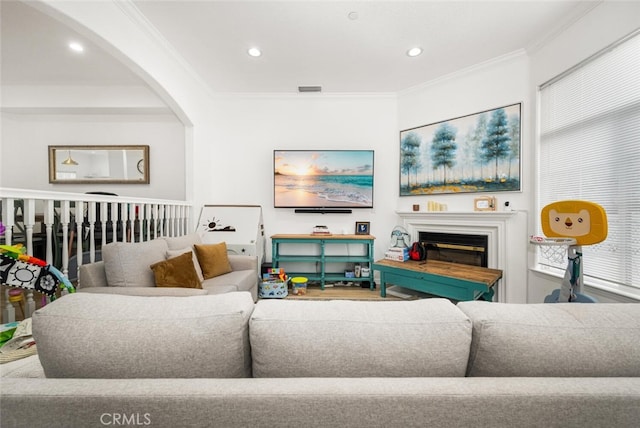 5740 S Glennie Ln Unit C, Los Angeles, CA 90016 - living room with ornamental molding, recessed lighting, arched walkways, and a glass covered fireplace