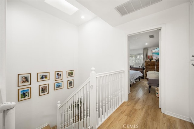 5740 S Glennie Ln Unit C, Los Angeles, CA 90016 - hallway featuring an upstairs landing, light wood-style floors, and recessed lighting