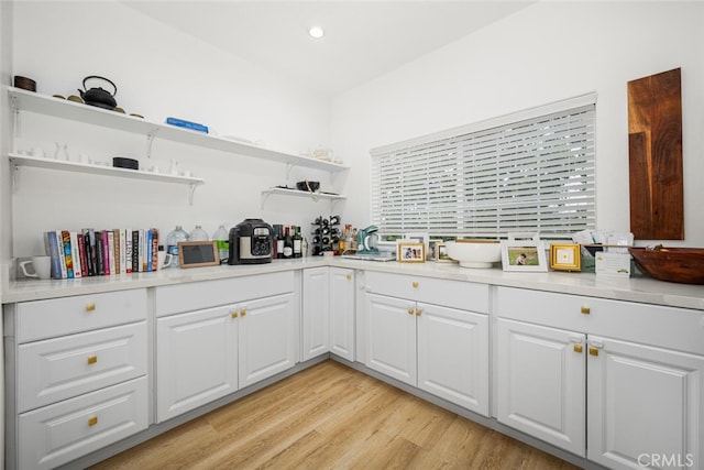 5740 S Glennie Ln Unit C, Los Angeles, CA 90016 - kitchen with open shelves, light countertops, light wood-type flooring, white cabinets, and recessed lighting
