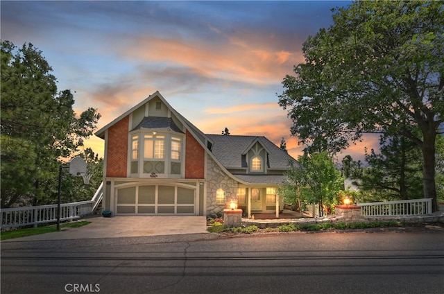 27781 St Bernard Ln, Lake Arrowhead, CA 92352 - view of front of home with stone siding, concrete driveway, and a garage