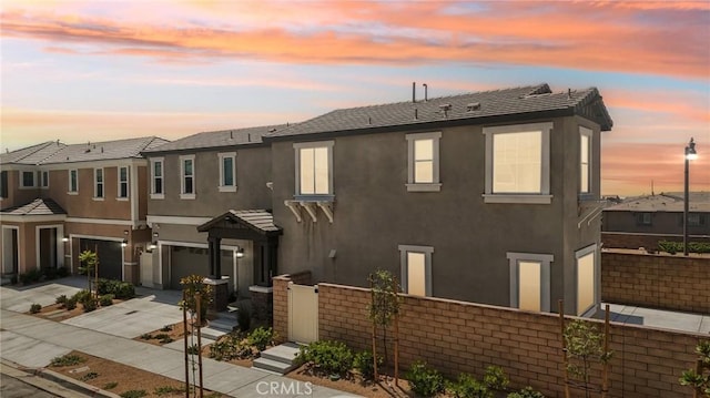 16773 Grapefruit Ln, Fontana, CA 92336 - view of property with an attached garage, concrete driveway, and stucco siding