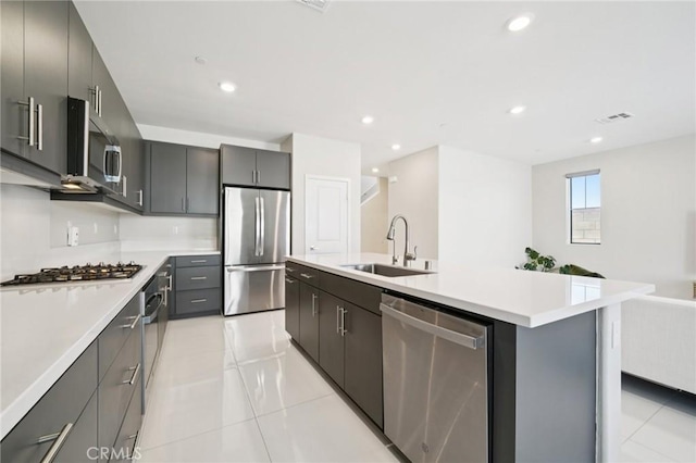16773 Grapefruit Ln, Fontana, CA 92336 - kitchen featuring stainless steel appliances, light tile patterned floors, light countertops, open floor plan, and recessed lighting